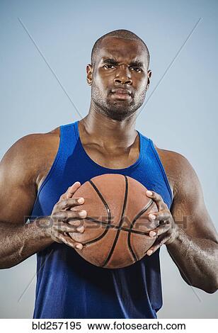 Confident black man holding basketball View Large Photo Image Stock Photography - Confident black man holding basketball. Fotosearch