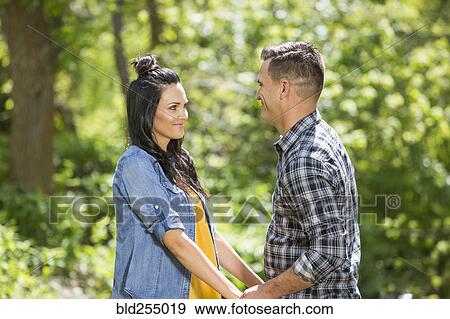 Stock Photo - Couple holding hands face to face. Fotosearch