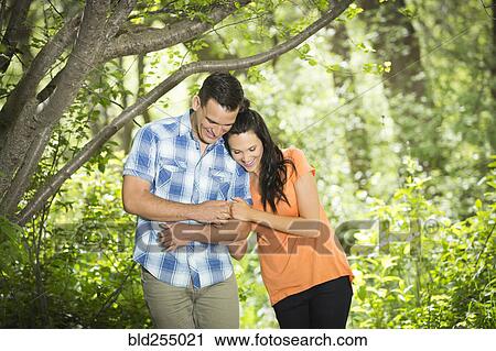 Couple hugging in the woods View Large Photo Image Stock Image - Couple hugging in the woods. Fotosearch