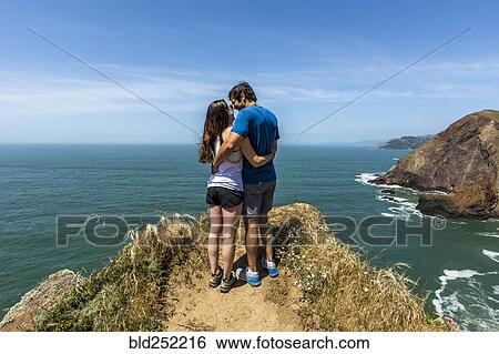 Couple hugging near scenic view of ocean View Large Photo Image Stock Photograph - Couple hugging near scenic view of ocean. Fotosearch