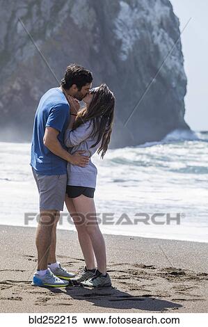 Stock Photography - Couple kissing on beach. Fotosearch