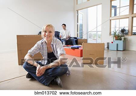 Stock Image - Couple moving into new house. Fotosearch