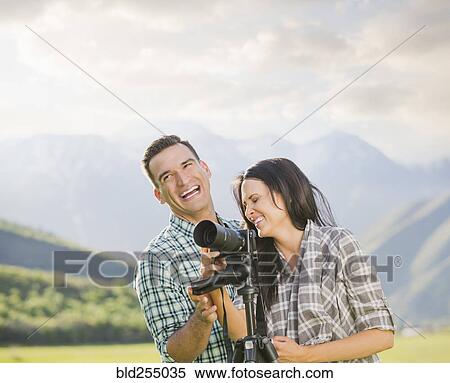 Couple with camera laughing View Large Photo Image Stock Photography - Couple with camera laughing. Fotosearch
