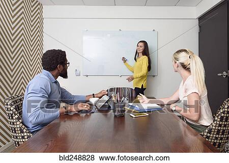 Creative business people meeting near whiteboard View Large Photo Image Stock Photo - Creative business people meeting near whiteboard. Fotosearch