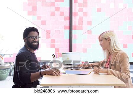 Creative business people using technology at table View Large Photo Image Stock Photography - Creative business people using technology at table. Fotosearch
