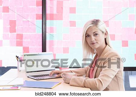 Picture - Creative Caucasian businesswoman using laptop. Fotosearch