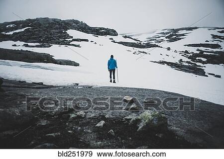 Distant Caucasian man hiking in winter View Large Photo Image Stock Photo - Distant Caucasian man hiking in winter. Fotosearch