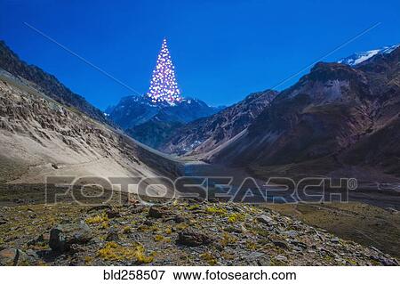 Distant Christmas tree on mountain View Large Photo Image Stock Photo - Distant Christmas tree on mountain. Fotosearch