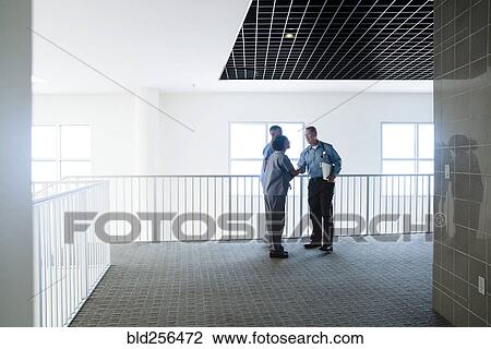Stock Image - Doctor and nurse shaking hands. Fotosearch