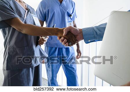 Doctor and nurse shaking hands View Large Photo Image Stock Image - Doctor and nurse shaking hands. Fotosearch