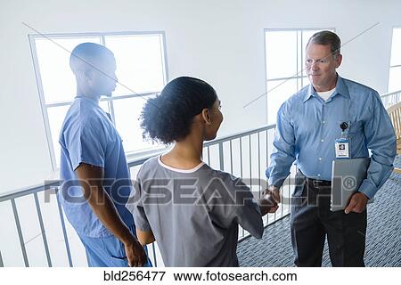 Doctor and nurse shaking hands View Large Photo Image Stock Photo - Doctor and nurse shaking hands. Fotosearch