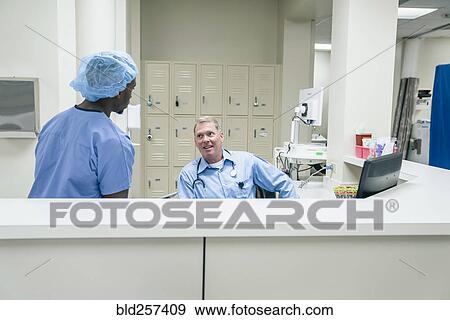 Doctor and nurse talking in hospital View Large Photo Image Stock Photo - Doctor and nurse talking in hospital. Fotosearch