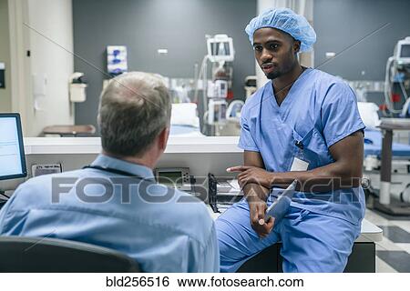 Doctor and nurse talking View Large Photo Image Stock Photograph - Doctor and nurse talking. Fotosearch