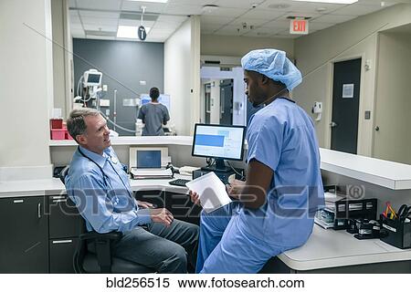 Stock Photography - Doctor and nurse talking. Fotosearch