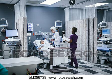 Doctor and nurse with patient in hospital View Large Photo Image Stock Photo - Doctor and nurse with patient in hospital. Fotosearch
