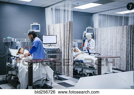 Doctor and nurse with patients in hospital View Large Photo Image Stock Photograph - Doctor and nurse with patients in hospital. Fotosearch