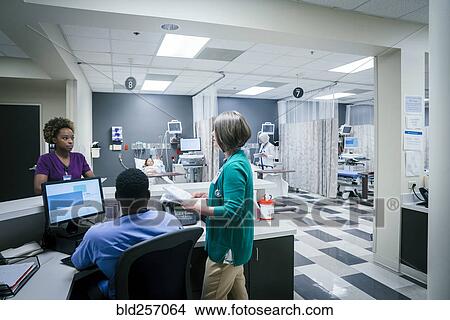 Picture - Doctor and nurses talking in hospital. Fotosearch