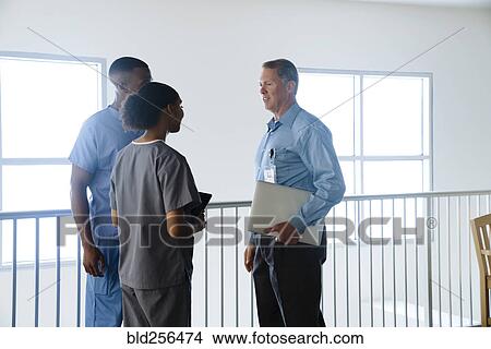 Picture - Doctor and nurses talking. Fotosearch
