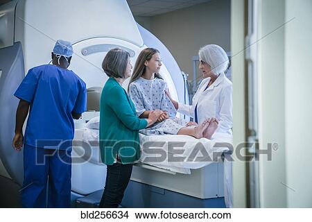 Doctor comforting patient at scanner View Large Photo Image Picture - Doctor comforting patient at scanner. Fotosearch