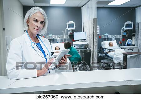 Stock Image - Doctor using digital tablet in hospital. Fotosearch