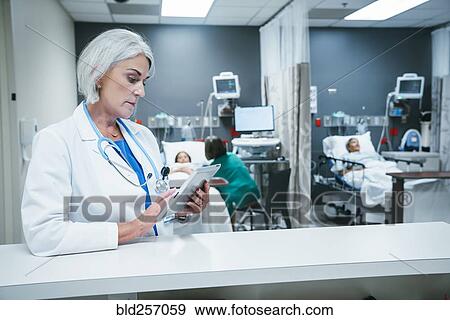 Stock Photo - Doctor using digital tablet in hospital. Fotosearch