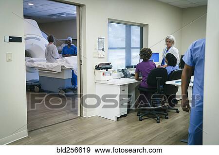Stock Photo - Doctors and nurses near scanner. Fotosearch