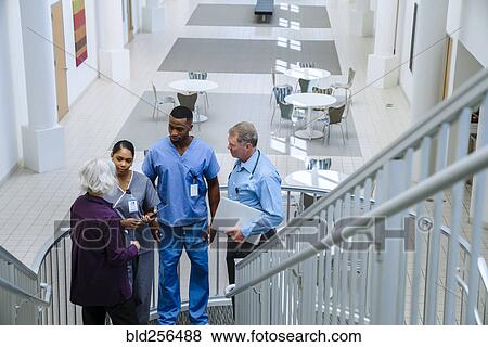 Doctors and nurses talking on staircase View Large Photo Image Stock Photo - Doctors and nurses talking on staircase. Fotosearch