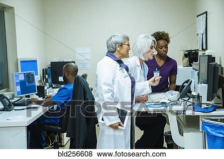 Stock Photo - Doctors and nurses using computers. Fotosearch