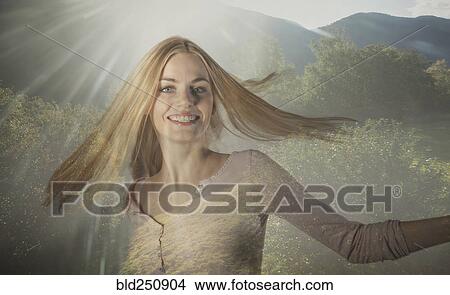 Picture - Double exposure of Caucasian woman spinning in forest trees. Fotosearch