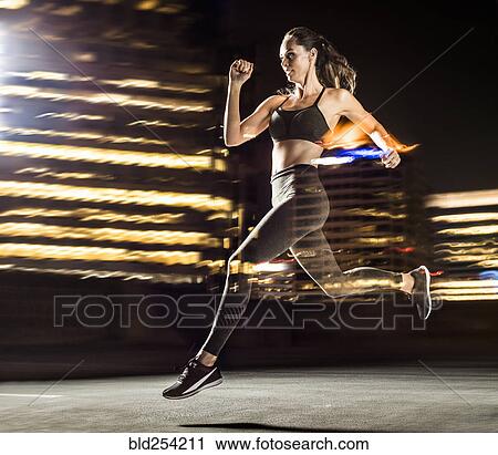 Stock Image - Double exposure of Caucasian woman running in city at night. Fotosearch