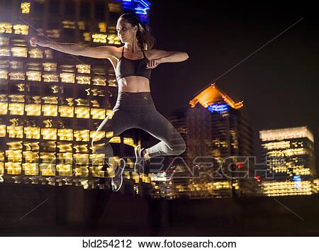 Double exposure of Caucasian woman jumping in city at night View Large Photo Image Stock Image - Double exposure of Caucasian woman jumping in city at night. Fotosearch