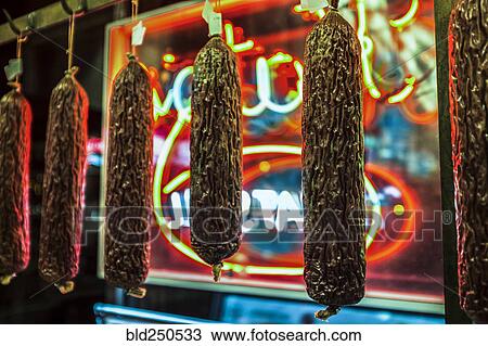 Dried meat handing near neon sign View Large Photo Image Stock Image - Dried meat handing near neon sign. Fotosearch