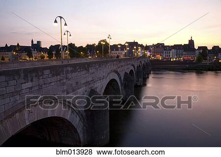 Stock Photo - Dutch canal and bridge at sunset. Fotosearch