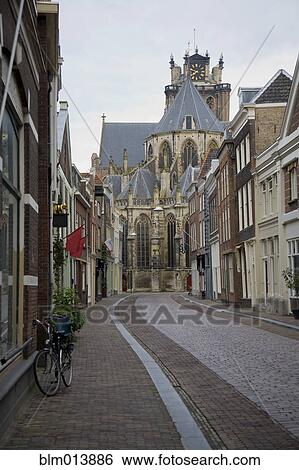 Stock Photograph - Dutch church and cobblestone street. Fotosearch