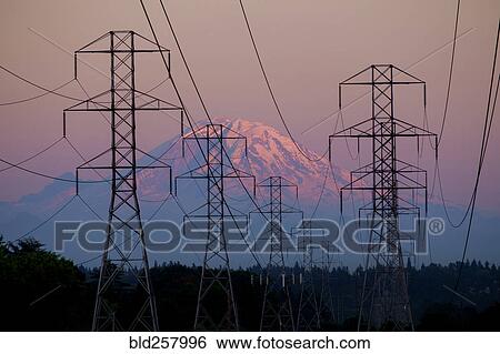 Stock Photograph - Electricity pylons near mountain landscape. Fotosearch