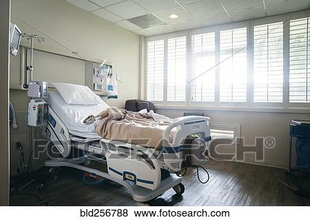 Stock Photo - Empty hospital bed near sunny window. Fotosearch