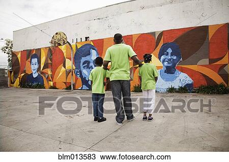 Stock Image - Father and children volunteering together. Fotosearch