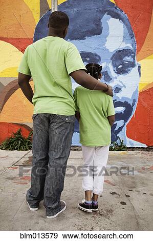 Father and daughter looking at mural View Large Photo Image Stock Photo - Father and daughter looking at mural. Fotosearch