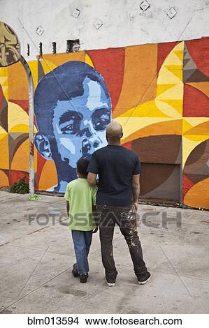 Father and son admiring mural View Large Photo Image Picture - Father and son admiring mural. Fotosearch
