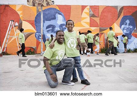 Stock Image - Father and son volunteering. Fotosearch