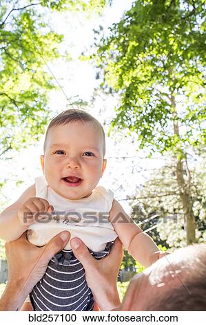 Father lifting baby daughter View Large Photo Image Stock Image - Father lifting baby daughter. Fotosearch