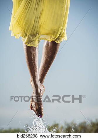 Stock Photo - Feet of Black dancing jumping in water. Fotosearch