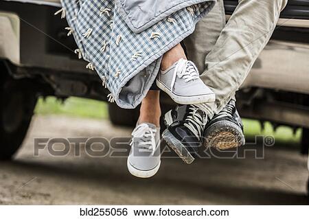 Feet of couple wrapped in blanket sitting on bed of pick-up truck View Large Photo Image Stock Photograph - Feet of couple wrapped in blanket sitting on bed of pick-up truck. Fotosearch