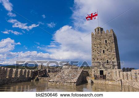 Flag blowing in wind on top of castle View Large Photo Image Stock Photograph - Flag blowing in wind on top of castle. Fotosearch