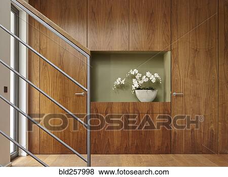 Stock Photo - Flowers and walnut wall covering in home. Fotosearch