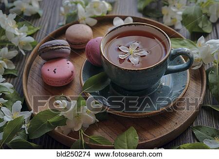 Picture - Flowers on tray with tea and macaroons. Fotosearch
