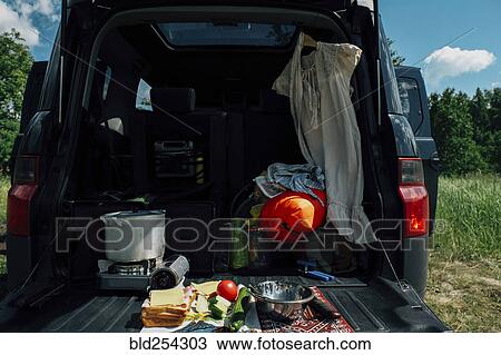 Stock Image - Food and camping gear in car. Fotosearch
