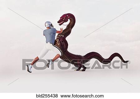 Stock Photo - Football player challenging dragon. Fotosearch