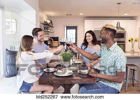 Friends eating cheese and toasting with red wine View Large Photo Image Stock Photo - Friends eating cheese and toasting with red wine. Fotosearch
