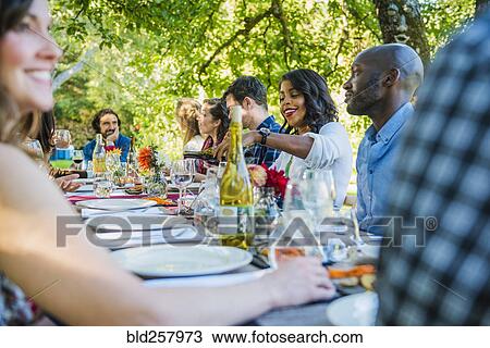 Friends enjoying wine at party outdoors View Large Photo Image Stock Image - Friends enjoying wine at party outdoors. Fotosearch